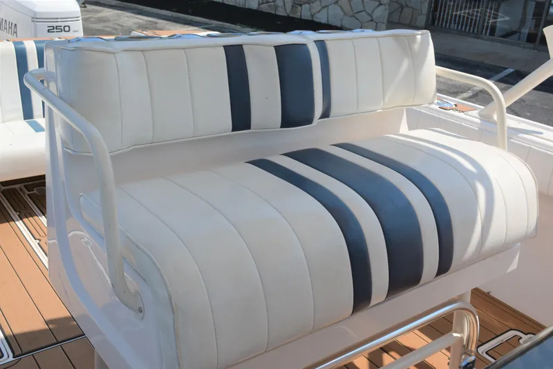 Slide: The Image of White and blue striped seating on a 2001 Intrepid 322 Cuddy boat. - 23