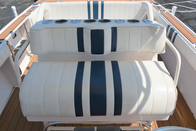Slide: The Image of 2001 Intrepid 322 Cuddy boat seating with blue and white striped upholstery. - 24