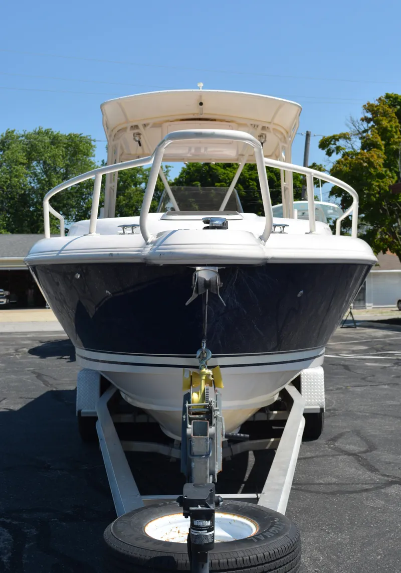 Slide: The Image of 2001 Intrepid 322 Cuddy boat on trailer, front view, sunny day. - 9