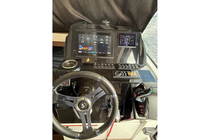 Slide: The Image of 2023 Beneteau Antares 9 helm with modern navigation displays and controls. - 10