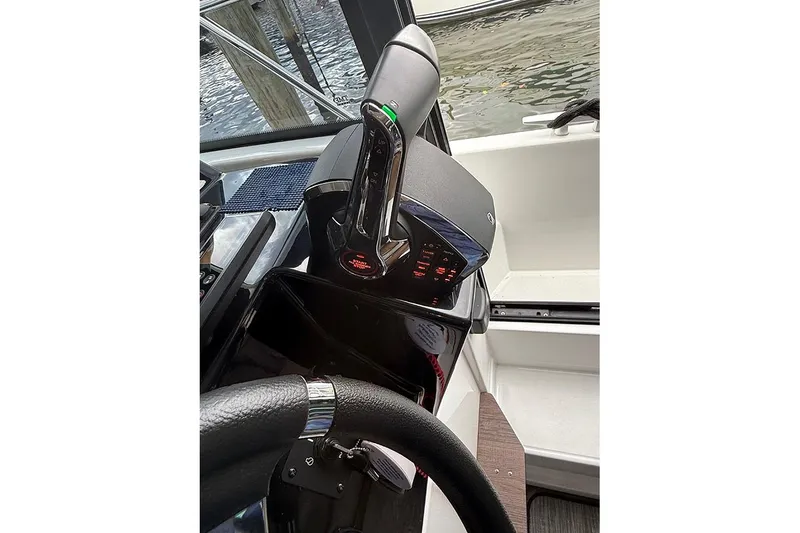 Slide: The Image of 2023 Beneteau Antares 9 helm with modern controls and steering wheel. - 12