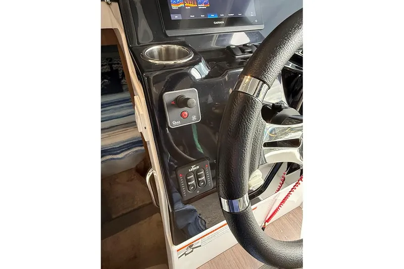 Slide: The Image of 2023 Beneteau Antares 9 helm with steering wheel, controls, and Garmin display. - 13