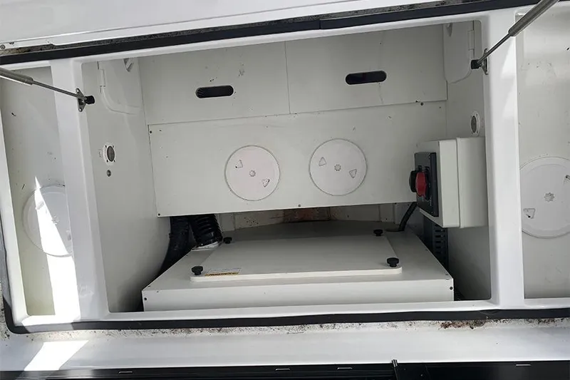 Slide: The Image of 2023 Beneteau Antares 9 storage compartment with mechanical components and wiring. - 16