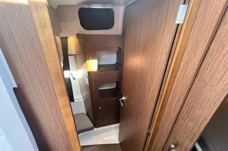 Slide: The Image of 2023 Beneteau Antares 9 interior with wooden cabinetry and modern design. - 19