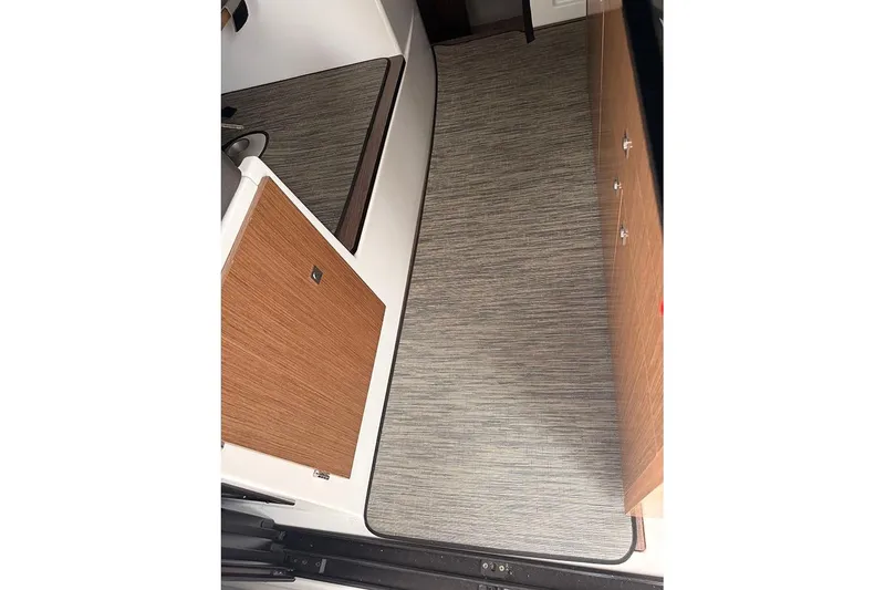 Slide: The Image of Interior view of 2023 Beneteau Antares 9, featuring modern wood cabinetry and flooring. - 24