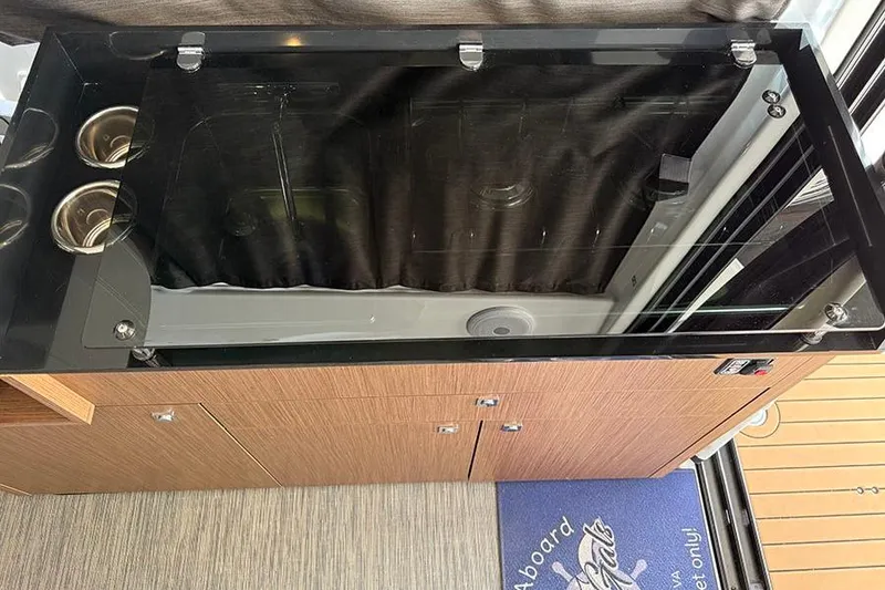 Slide: The Image of Interior view of 2023 Beneteau Antares 9 kitchen area with sleek countertop and storage. - 26