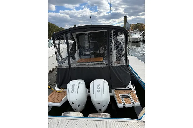 Slide: The Image of 2023 Beneteau Antares 9 with dual outboard engines docked at marina. - 3