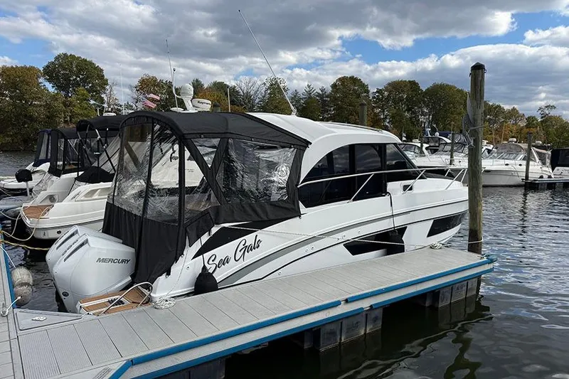 Slide: The Image of 2023 Beneteau Antares 9 docked, featuring sleek design and Mercury engine. - 5