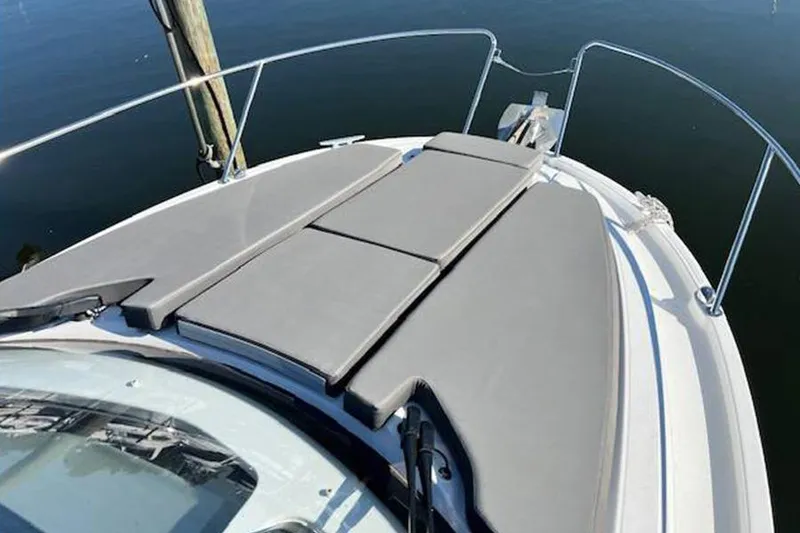 Slide: The Image of 2023 Beneteau Antares 9 boat with cushioned sunbathing area on deck. - 7