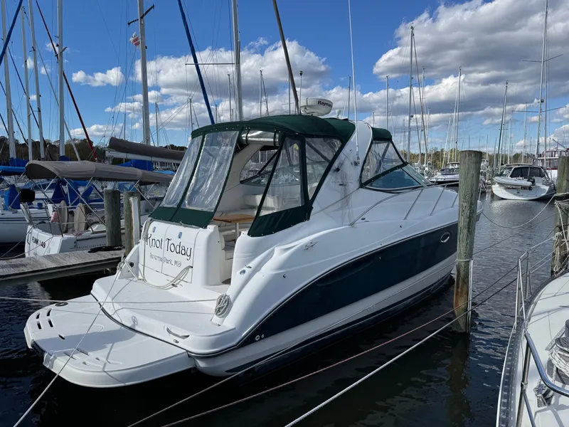The Image of 2001 Maxum 3500 SCR yacht docked at marina under blue sky. - 0
