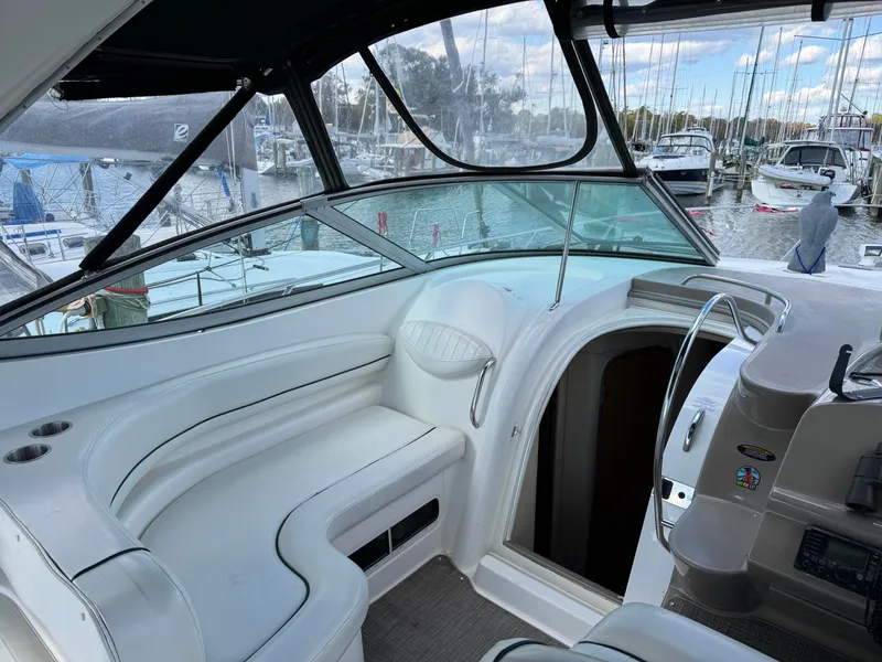 Slide: The Image of 2001 Maxum 3500 SCR yacht interior with white seating, docked at marina. - 12
