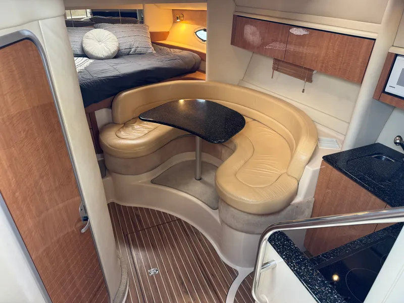 Slide: The Image of 2001 Maxum 3500 SCR yacht interior with cozy seating and elegant wood finishes. - 2
