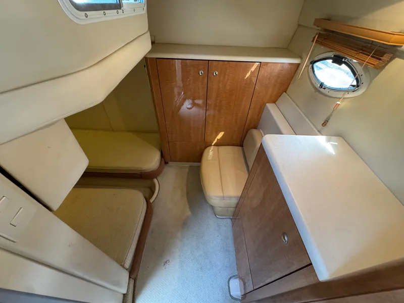 Slide: The Image of 2001 Maxum 3500 SCR cabin interior with wooden cabinets and seating. - 26