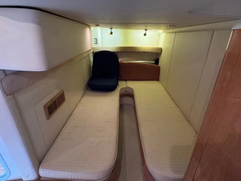 Slide: The Image of 2001 Maxum 3500 SCR cabin interior with beige seating and overhead lighting. - 27