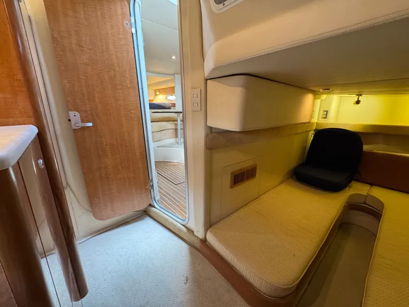 Slide: The Image of 2001 Maxum 3500 SCR cabin interior with cozy seating and wooden accents. - 28