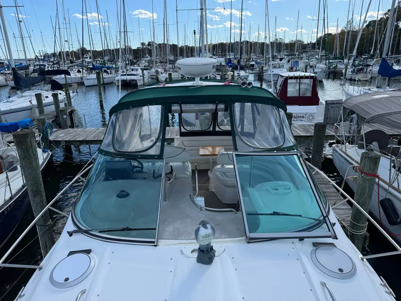 Slide: The Image of 2001 Maxum 3500 SCR yacht docked at a marina, surrounded by sailboats. - 32