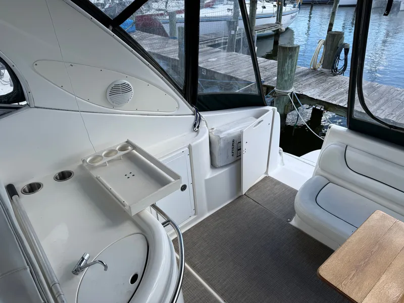 Slide: The Image of 2001 Maxum 3500 SCR boat interior with sink, seating, and dock view. - 9