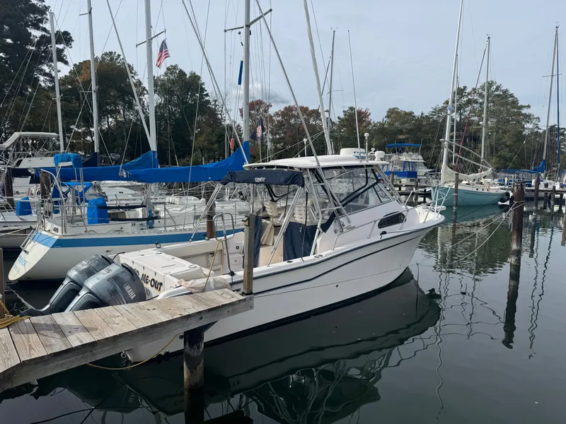 The Image of 2004 Grady-White Marlin 300 boat docked in a marina with other sailboats. - 0