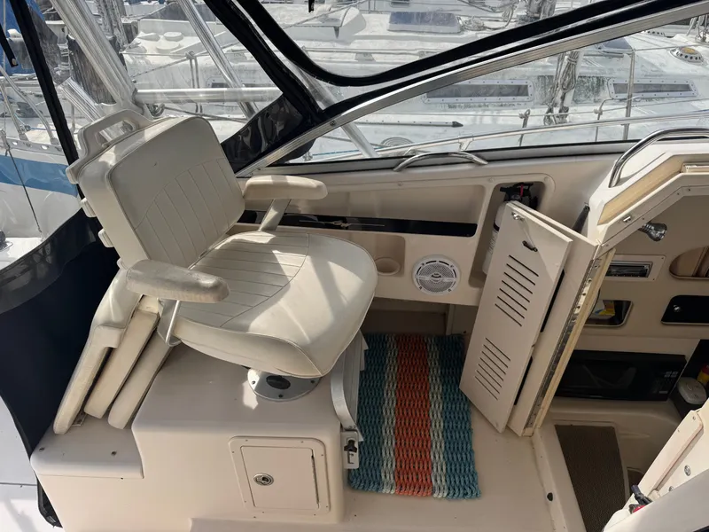 Slide: The Image of 2004 Grady-White Marlin 300 boat interior with captain's chair and cabin entrance. - 10