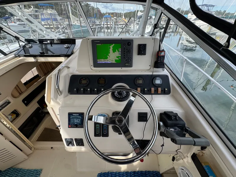 Slide: The Image of 2004 Grady-White Marlin 300 helm with navigation equipment and steering wheel. - 13
