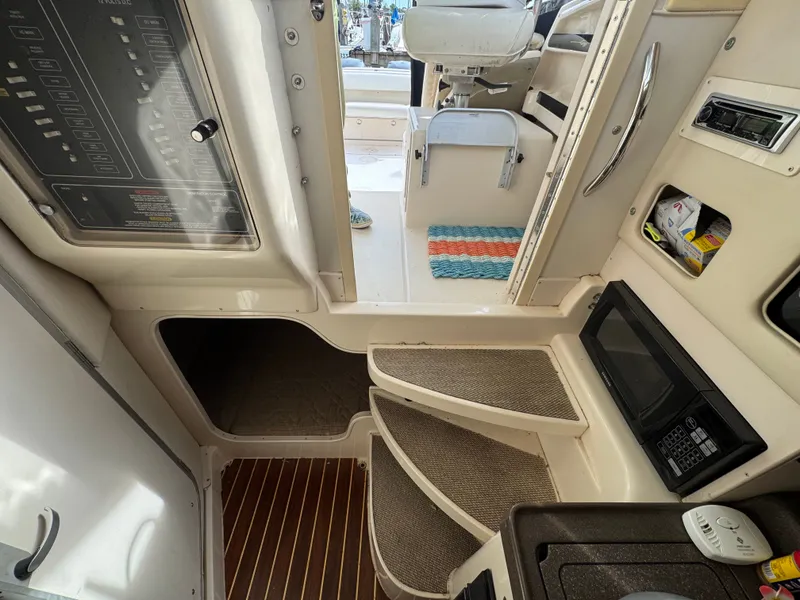 Slide: The Image of 2004 Grady-White Marlin 300 cabin interior with stairs, microwave, and control panel. - 18