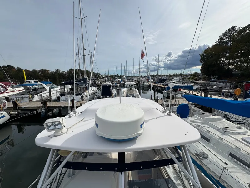 Slide: The Image of 2004 Grady-White Marlin 300 docked among other boats in a marina. - 34