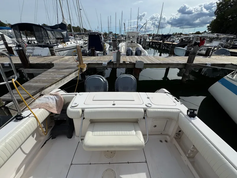 Slide: The Image of 2004 Grady-White Marlin 300 docked at a marina with other boats. - 4