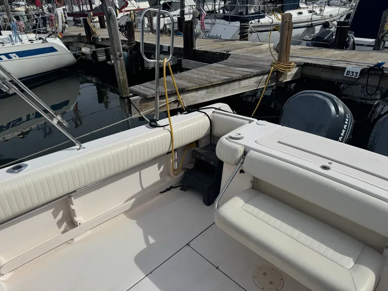 Slide: The Image of 2004 Grady-White Marlin 300 boat docked, featuring spacious seating and dual Yamaha engines. - 5