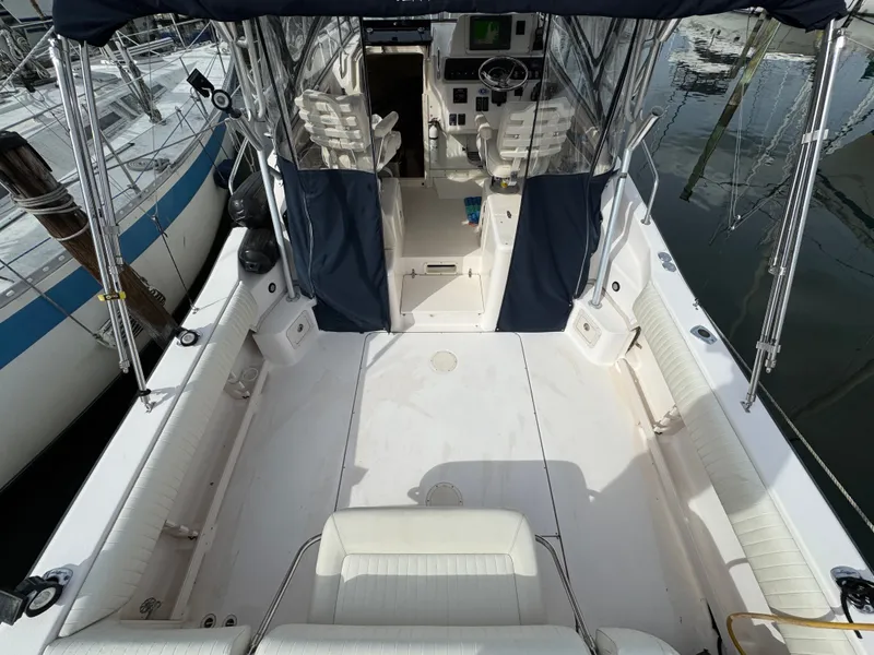 Slide: The Image of 2004 Grady-White Marlin 300 boat interior with seating and helm, docked at marina. - 7