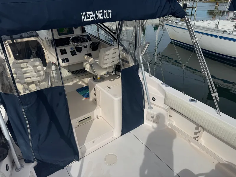 Slide: The Image of 2004 Grady-White Marlin 300 boat interior with helm and seating area. - 9