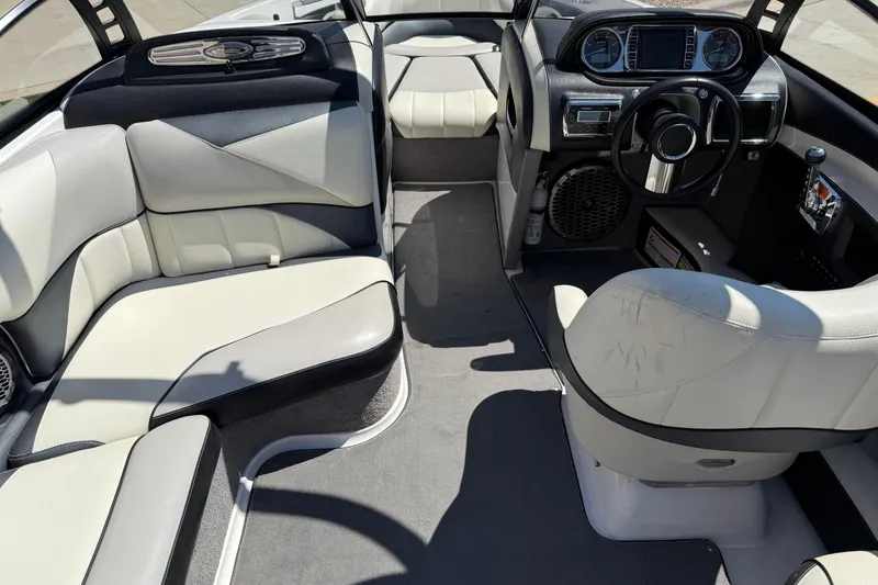 Slide: The Image of Interior of a 2011 Malibu Wakesetter 247 LSV boat, featuring sleek seating and modern dashboard. - 13