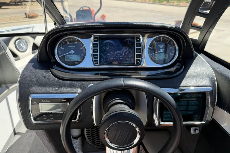 Slide: The Image of 2011 Malibu Wakesetter 247 LSV dashboard with gauges and steering wheel. - 18