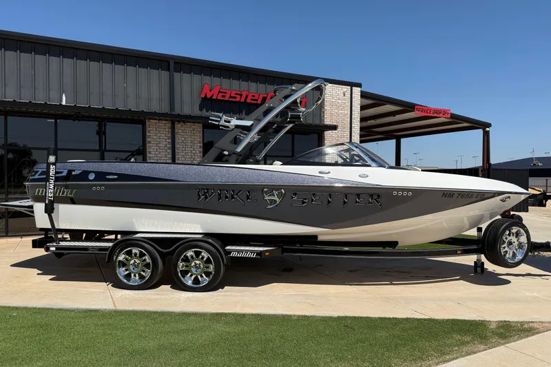 Slide: The Image of 2011 Malibu Wakesetter 247 LSV boat on trailer outside dealership. - 2
