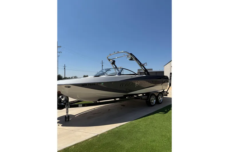 Slide: The Image of 2011 Malibu Wakesetter 247 LSV boat on trailer under clear blue sky. - 8