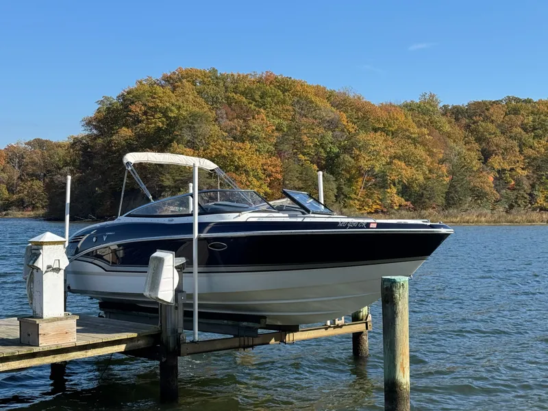 The Image of 2014 Formula 270 Bowrider boat docked on a lake with autumn trees in the background. - 0