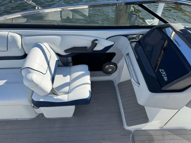 Slide: The Image of 2014 Formula 270 Bowrider interior with white seating and dashboard details. - 14