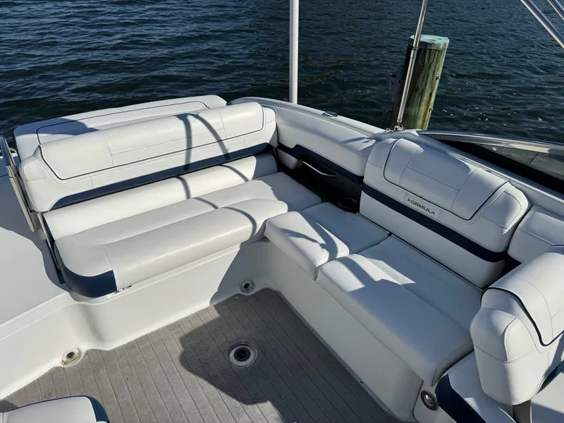 Slide: The Image of 2014 Formula 270 Bowrider boat interior with white seating and water view. - 15