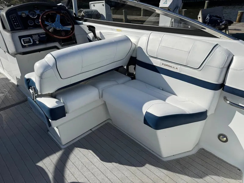 Slide: The Image of 2014 Formula 270 Bowrider interior with white and blue seating, sleek dashboard. - 18