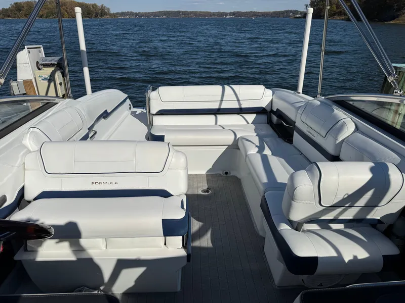 Slide: The Image of 2014 Formula 270 Bowrider boat with spacious white seating on a lake. - 27