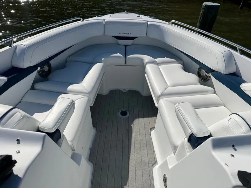 Slide: The Image of 2014 Formula 270 Bowrider boat interior with white seating and carpeted floor. - 4