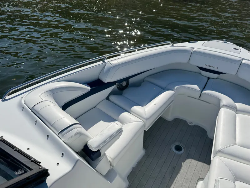 Slide: The Image of 2014 Formula 270 Bowrider boat with white seating, on calm water. - 6
