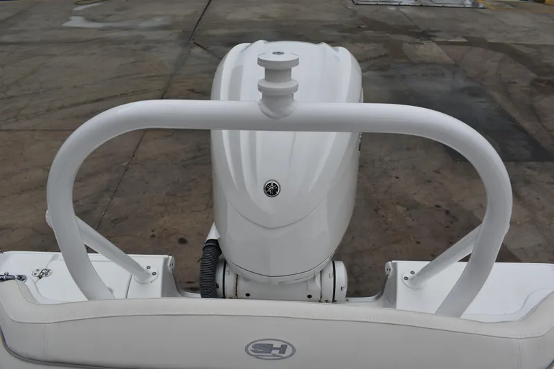 Slide: The Image of 2023 Sea Hunt Ultra 255 SE boat engine and railing, viewed from the rear. - 10