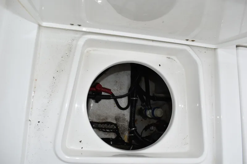 Slide: The Image of 2023 Sea Hunt Ultra 255 SE boat compartment with visible wiring and components. - 12