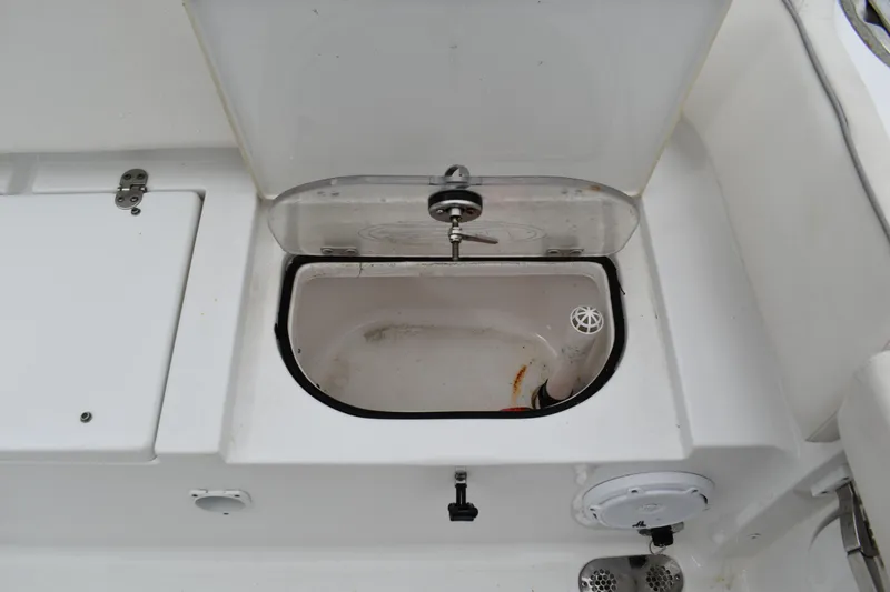 Slide: The Image of Livewell compartment on 2023 Sea Hunt Ultra 255 SE boat, open lid view. - 14