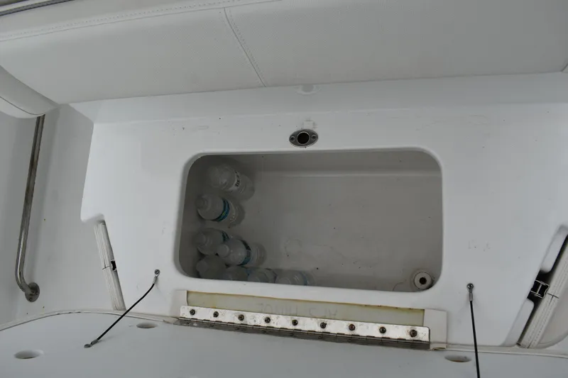 Slide: The Image of Storage compartment with water bottles in 2023 Sea Hunt Ultra 255 SE boat. - 17
