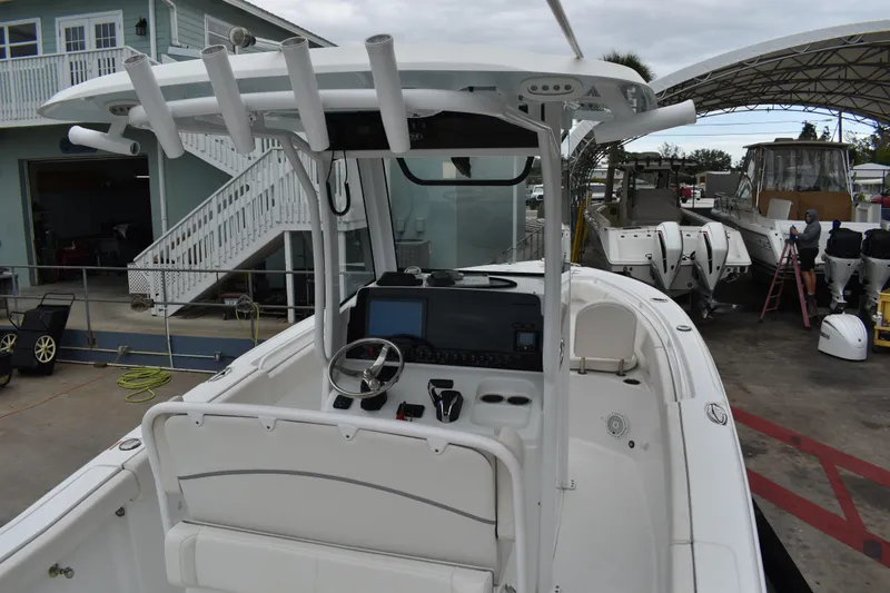 Slide: The Image of 2023 Sea Hunt Ultra 255 SE boat interior with helm and seating area. - 18