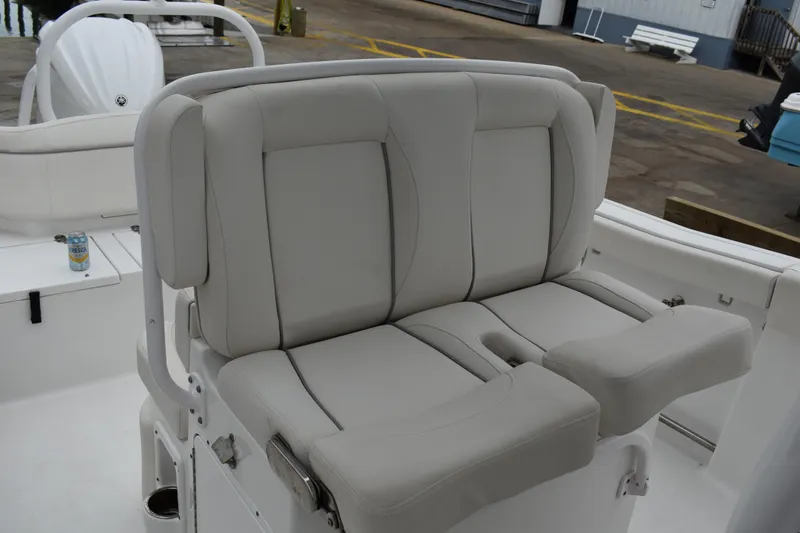 Slide: The Image of 2023 Sea Hunt Ultra 255 SE boat seating with light gray upholstery. - 20