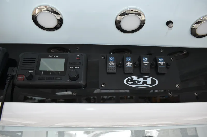 Slide: The Image of Control panel of 2023 Sea Hunt Ultra 255 SE boat with Garmin device and switches. - 21