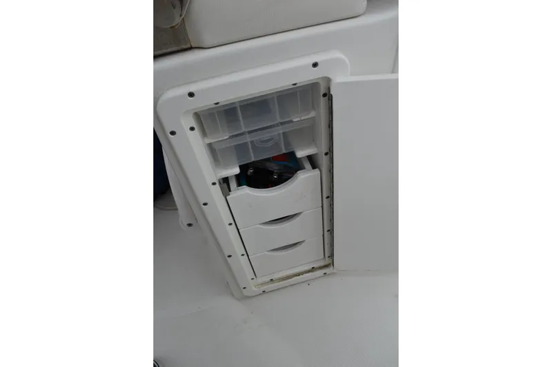 Slide: The Image of Storage compartment on 2023 Sea Hunt Ultra 255 SE boat, featuring organized drawers. - 34