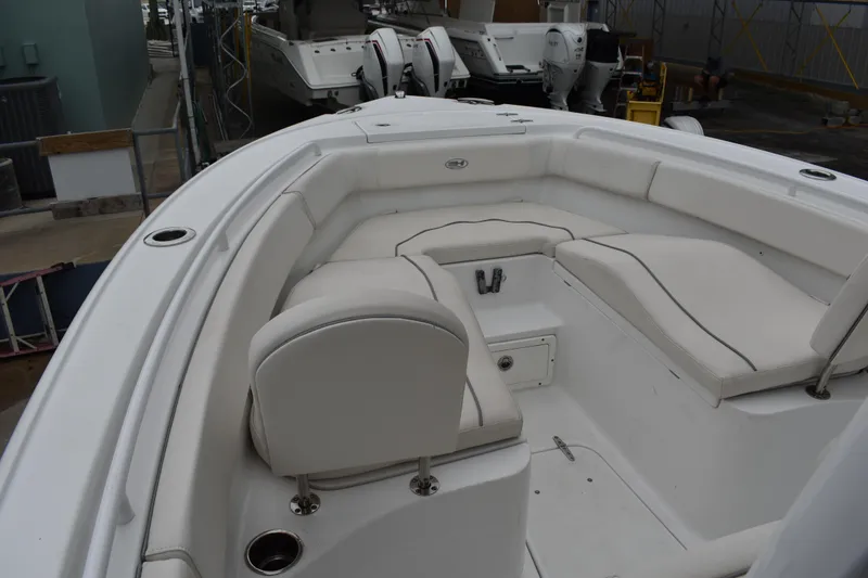 Slide: The Image of 2023 Sea Hunt Ultra 255 SE boat interior with white seating and cup holders. - 35